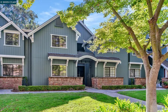 a front view of a house with a yard and porch