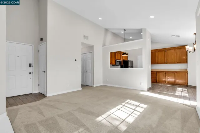 a view of an empty room and a window