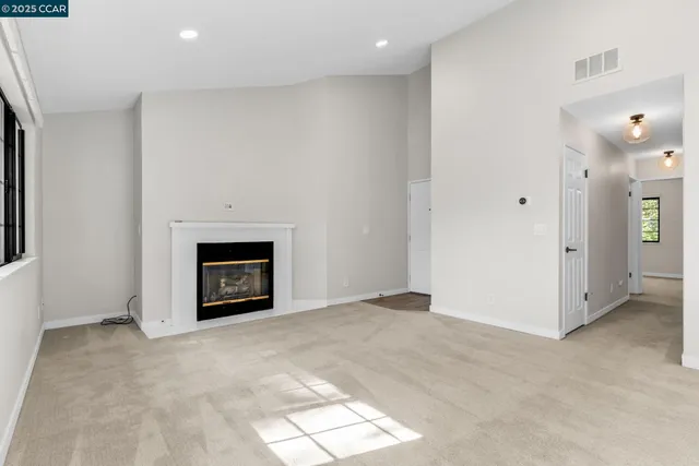 a view of an empty room with a fireplace