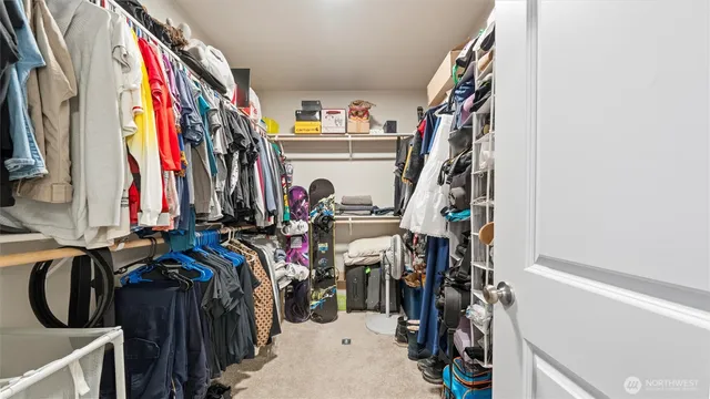 a view of walk in closet with clothes