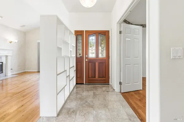 a view of a hallway with wooden floor and staircase