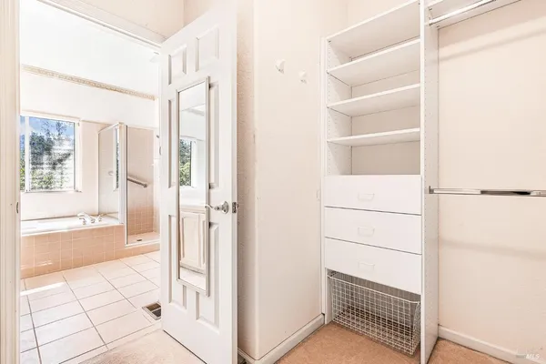 a view of a walk in closet and bedroom