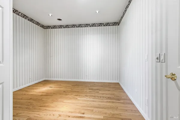 a view of room with wooden floor