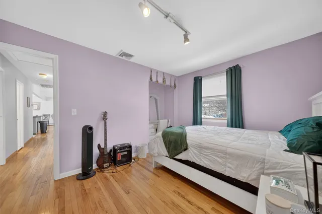 a bedroom with furniture and a wooden floor