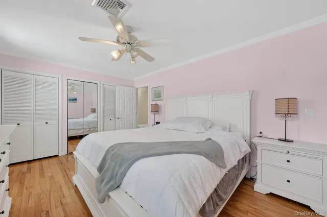 a bedroom with a large bed and a chandelier