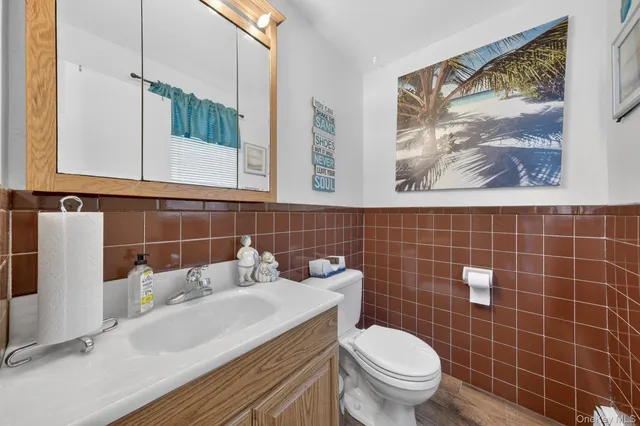 a bathroom with a sink a toilet and a mirror