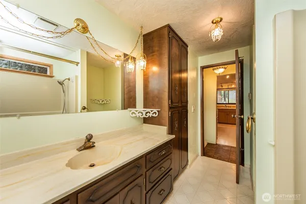 a spacious bathroom with a sink and a mirror