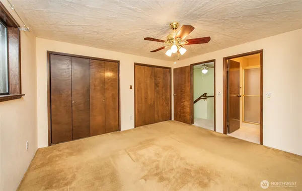 a view of a room with a ceiling fan