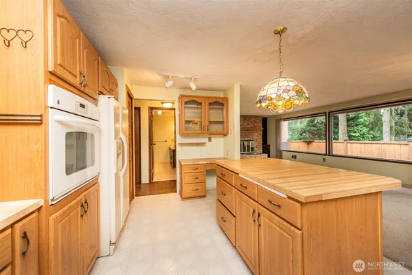 a open kitchen with stainless steel appliances granite countertop a stove and refrigerator