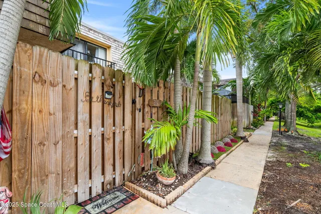 an aerial view of a house with a yard and garden