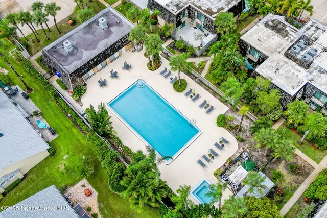 an aerial view of a house with garden space and street view