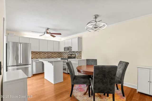 a kitchen with stainless steel appliances and white cabinets