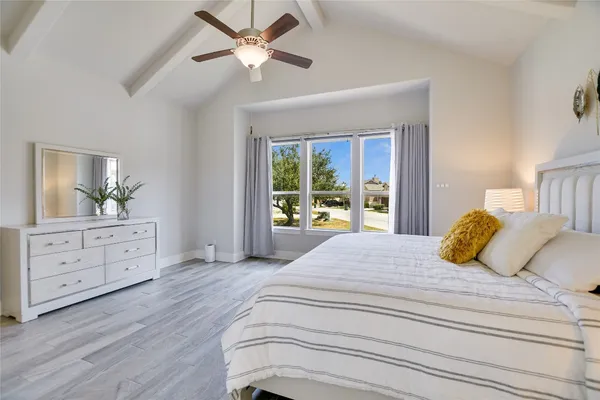 a bedroom with a large bed and a window