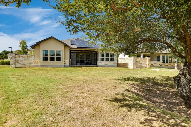 a large tree in front of house
