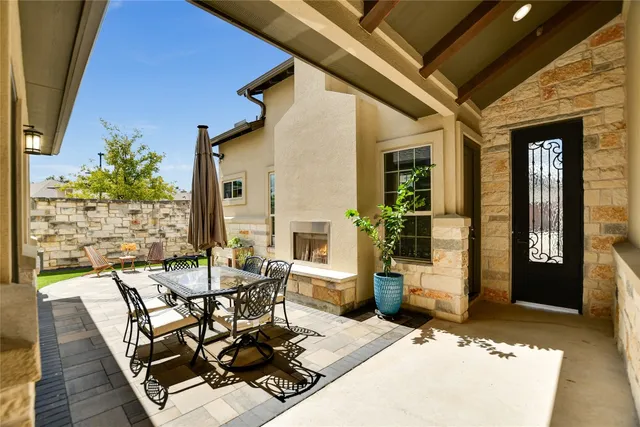 a view of a patio with table and chairs and potted plants