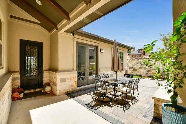 a living room with patio furniture and a potted plant