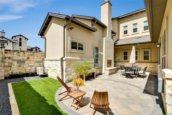 a view of a patio with table and chairs with wooden floor and fence