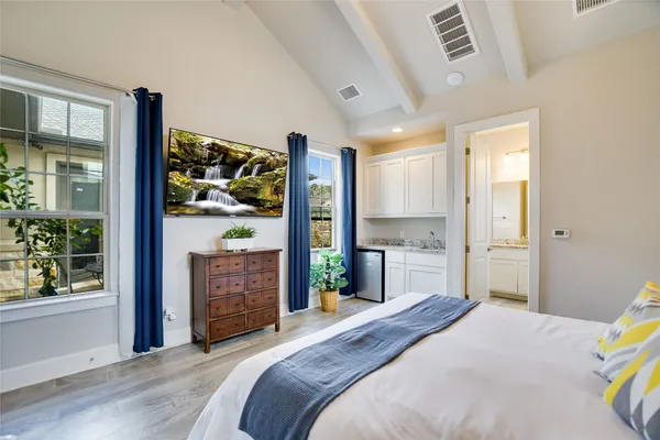 a bedroom with a bed and a dresser