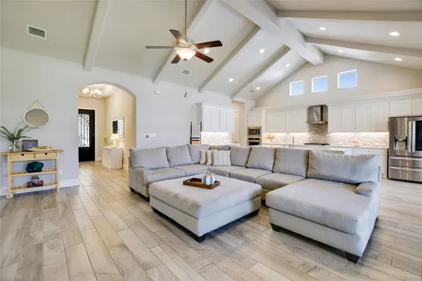a living room with furniture and a chandelier