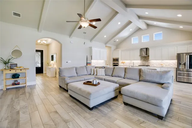 a living room with furniture and a chandelier