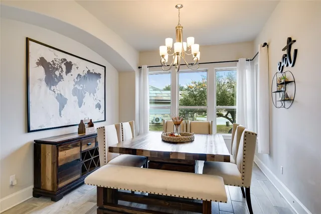 a view of a dining room with furniture wooden floor and chandelier