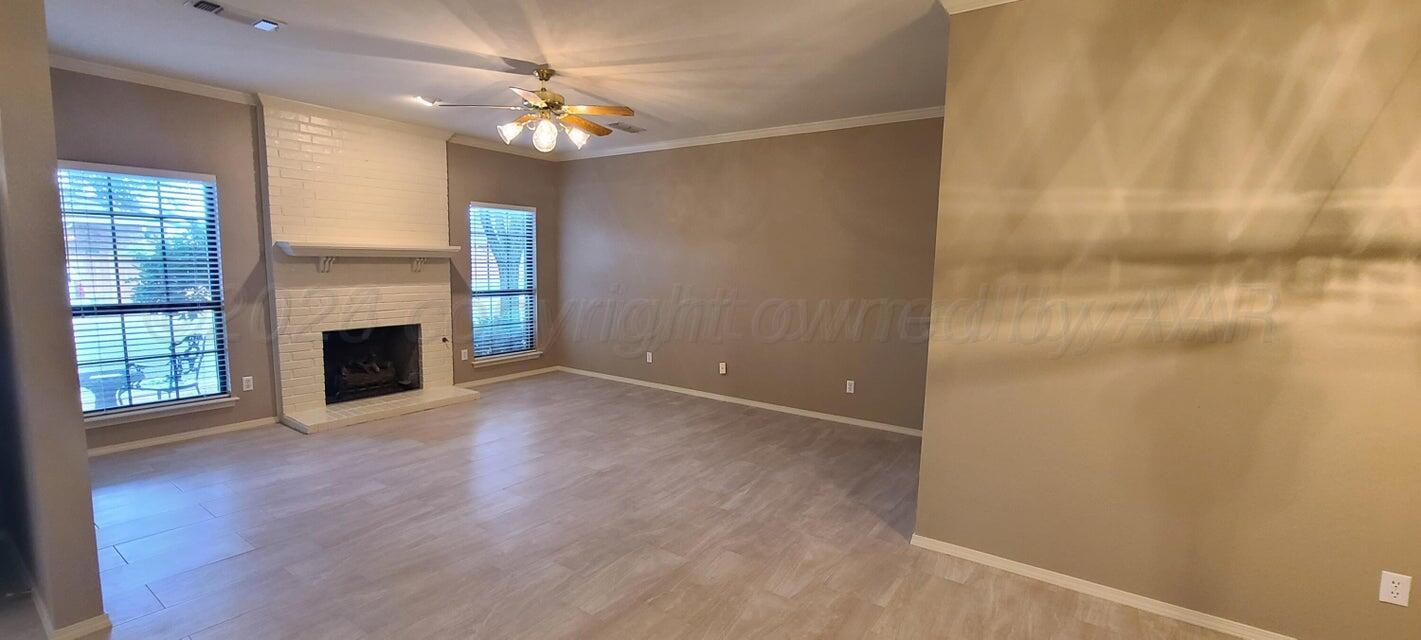 3531 West Point Drive Amarillo, TX 79119 - Photo 3 of 12 an empty room with windows and fireplace