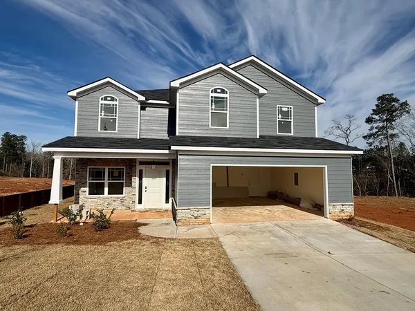 a front view of a house with a yard and garage