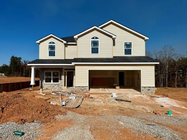 a view of house with yard and front view of a house