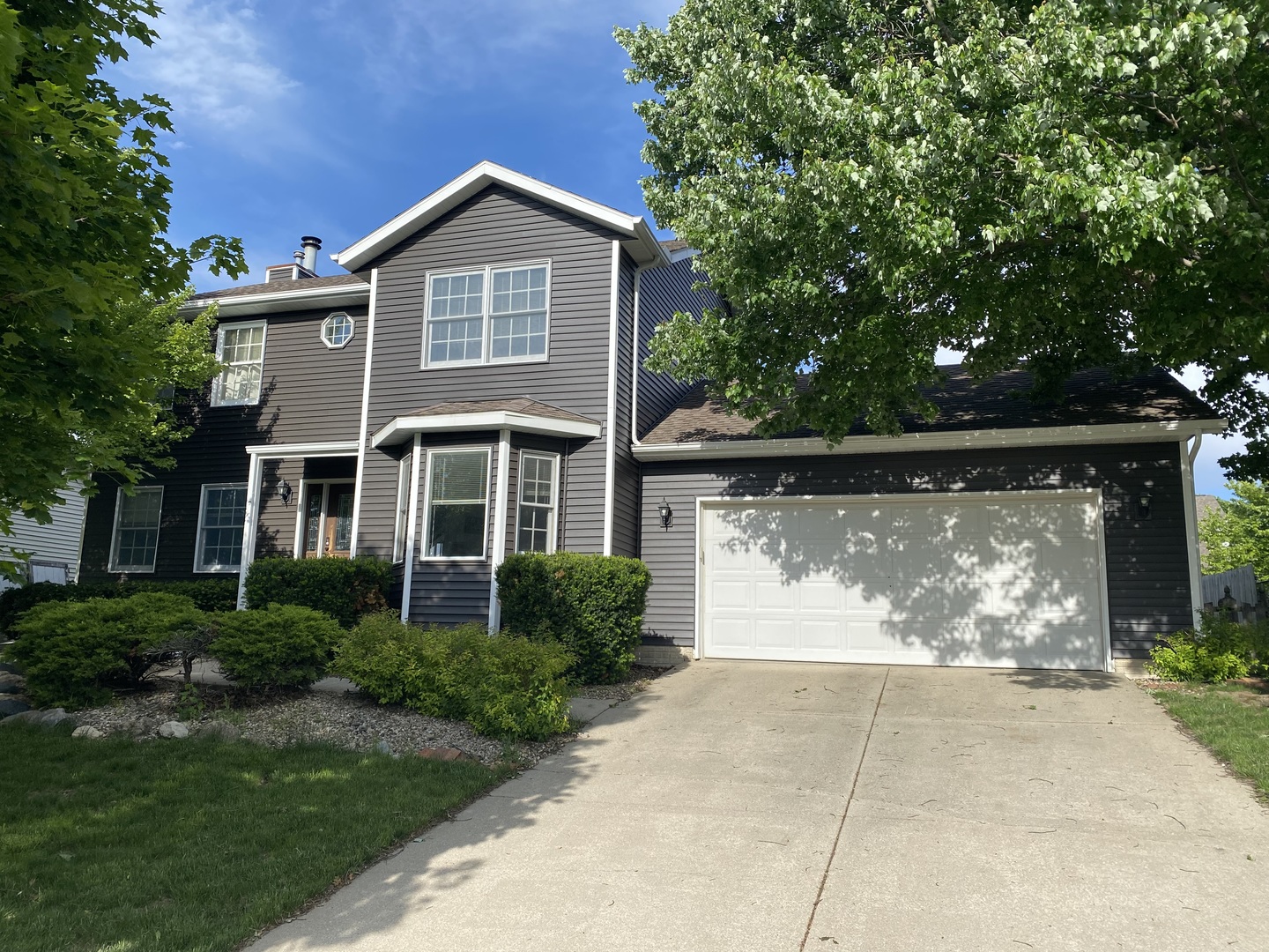 8 Holder Way Bloomington, IL 61704 - Photo 1 of 44 a front view of a house with garden