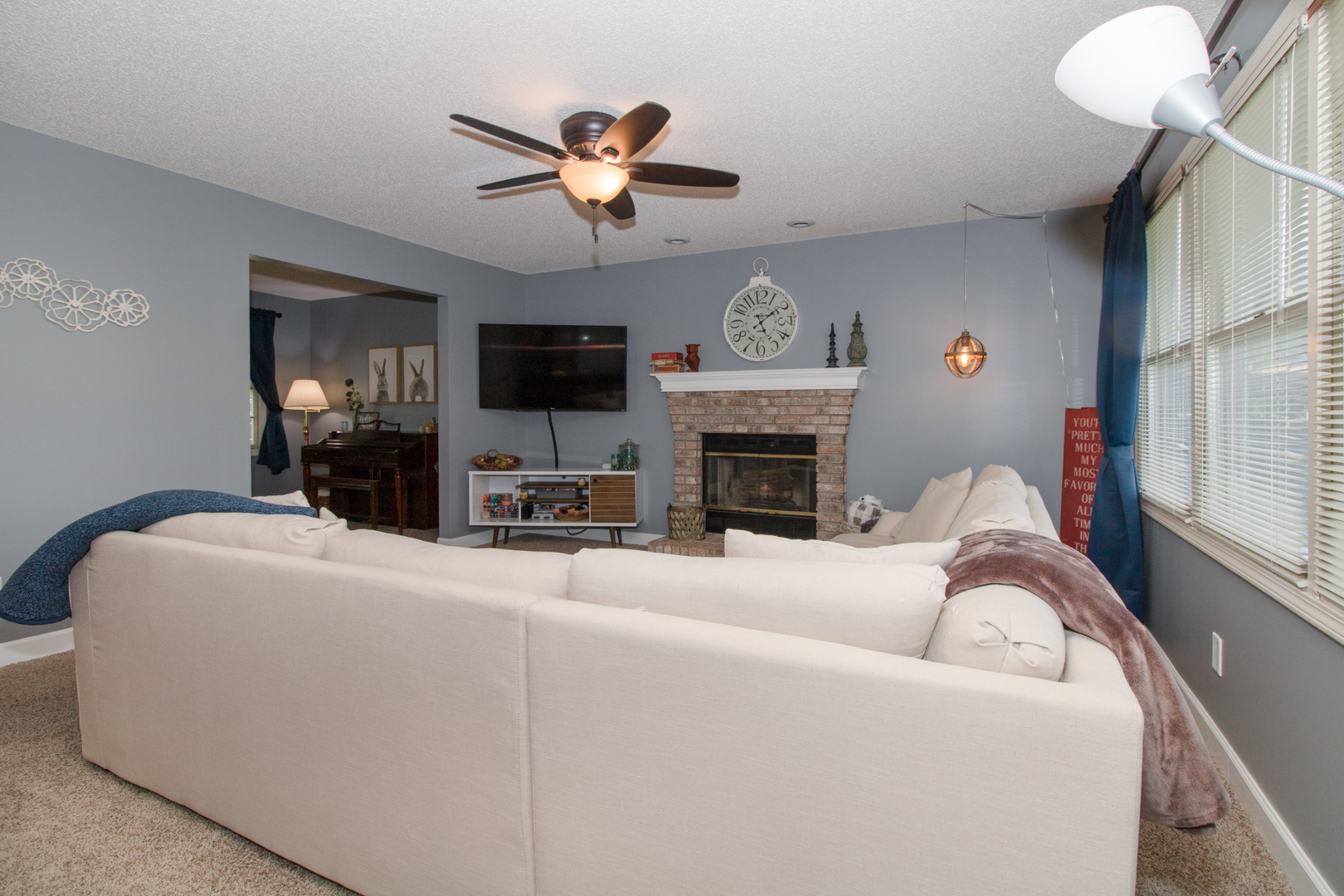 8 Holder Way Bloomington, IL 61704 - Photo 16 of 44 a living room with furniture a fireplace and a flat screen tv
