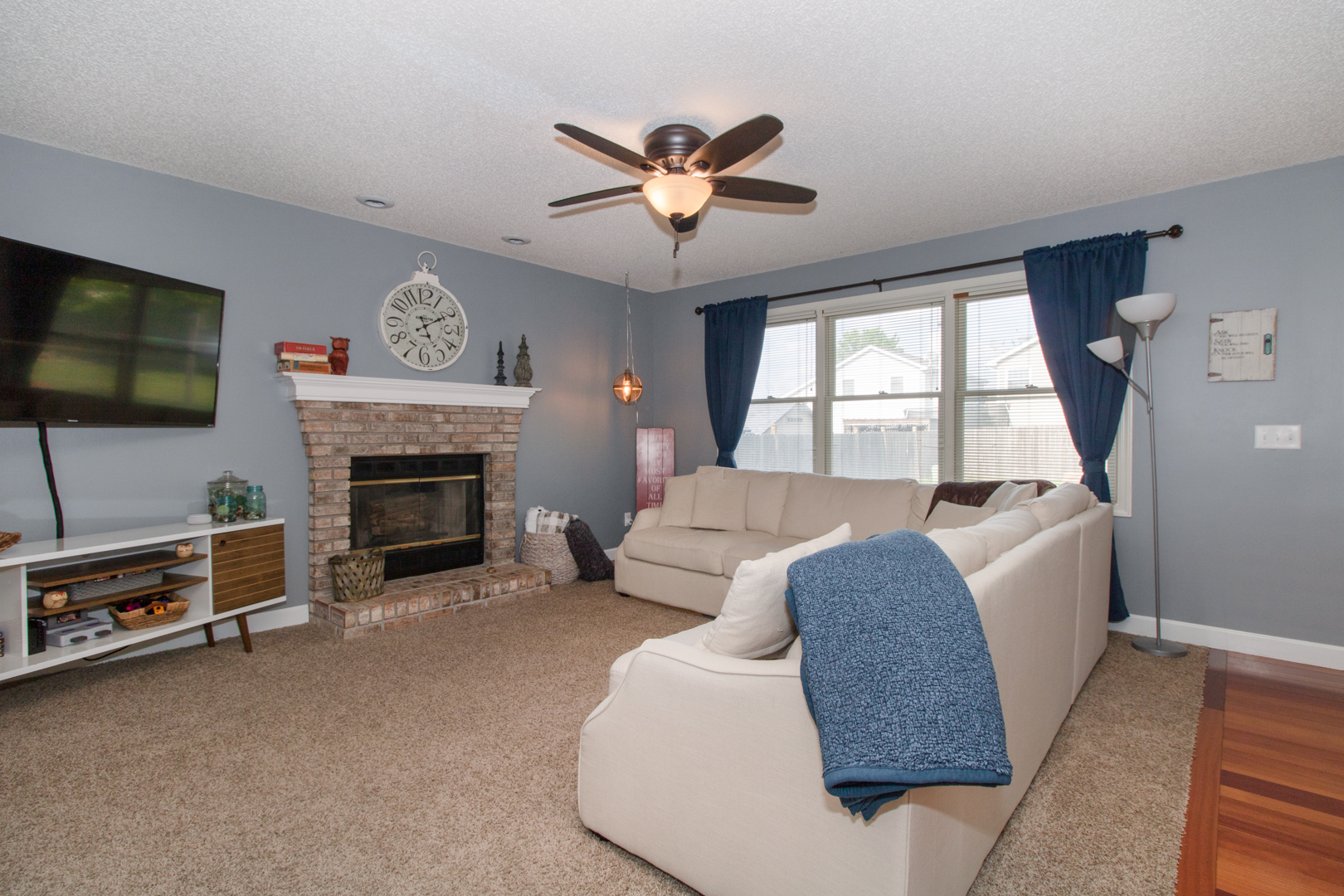 8 Holder Way Bloomington, IL 61704 - Photo 19 of 44 a living room with furniture a flat screen tv and a fireplace
