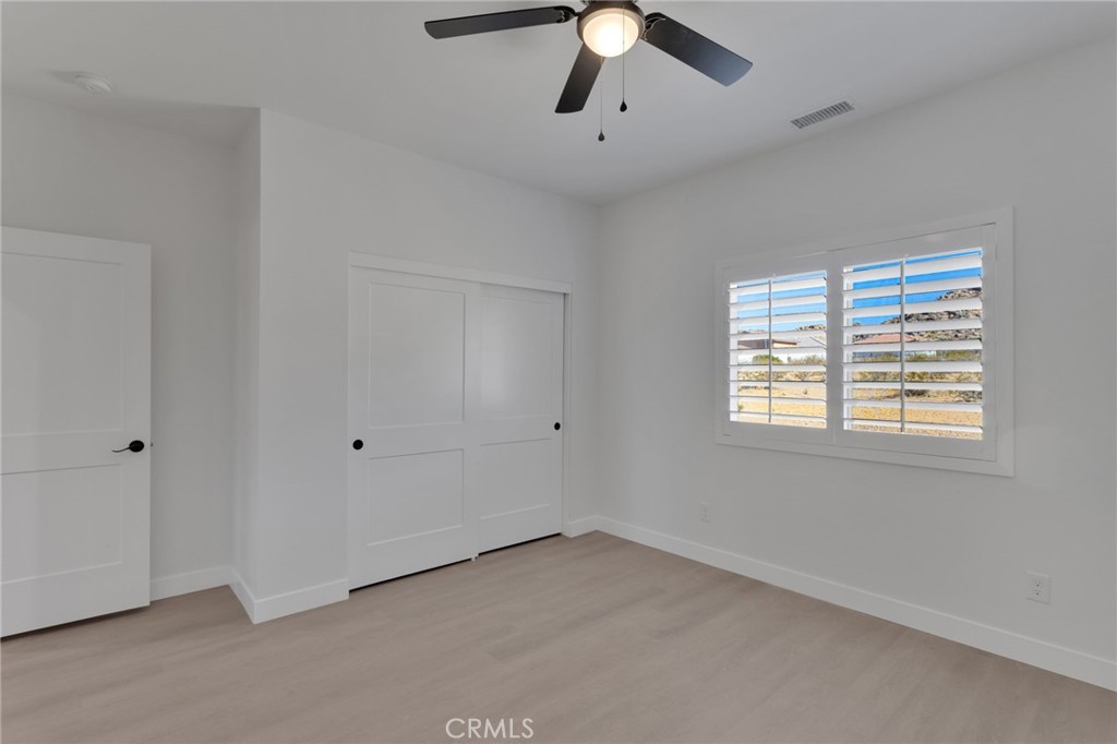 15575 Desert Star Road Apple Valley, CA 92307 - Photo 12 of 24 a view of an empty room with a window