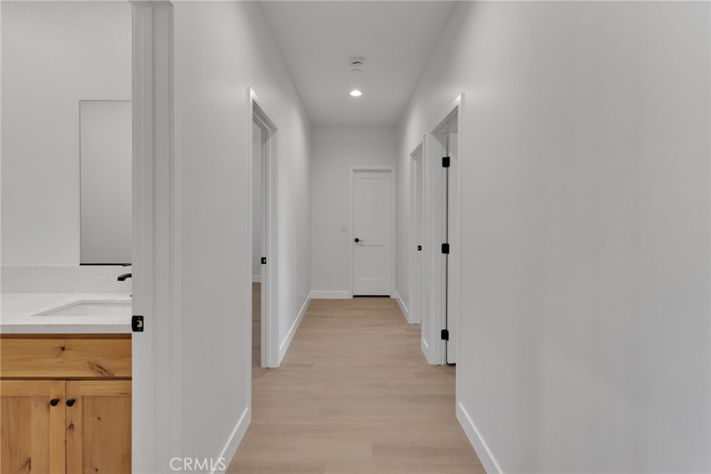 15575 Desert Star Road Apple Valley, CA 92307 - Photo 15 of 24 a view of a hallway with wooden shelves