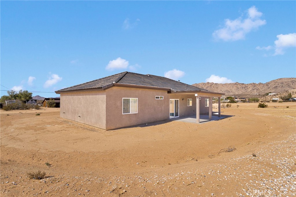 15575 Desert Star Road Apple Valley, CA 92307 - Photo 20 of 24 a front view of a house with a yard