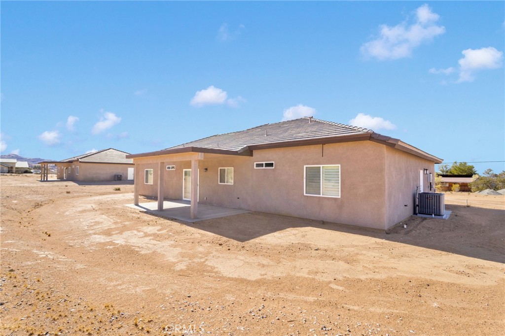15575 Desert Star Road Apple Valley, CA 92307 - Photo 22 of 24 a front view of a house with a yard