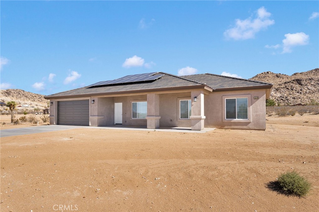 15575 Desert Star Road Apple Valley, CA 92307 - Photo 23 of 24 a front view of a house with a yard and garage