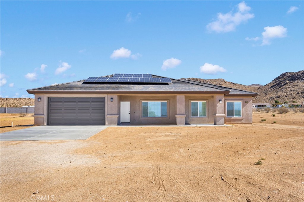 15575 Desert Star Road Apple Valley, CA 92307 - Photo 24 of 24 a front view of a house with a yard and garage