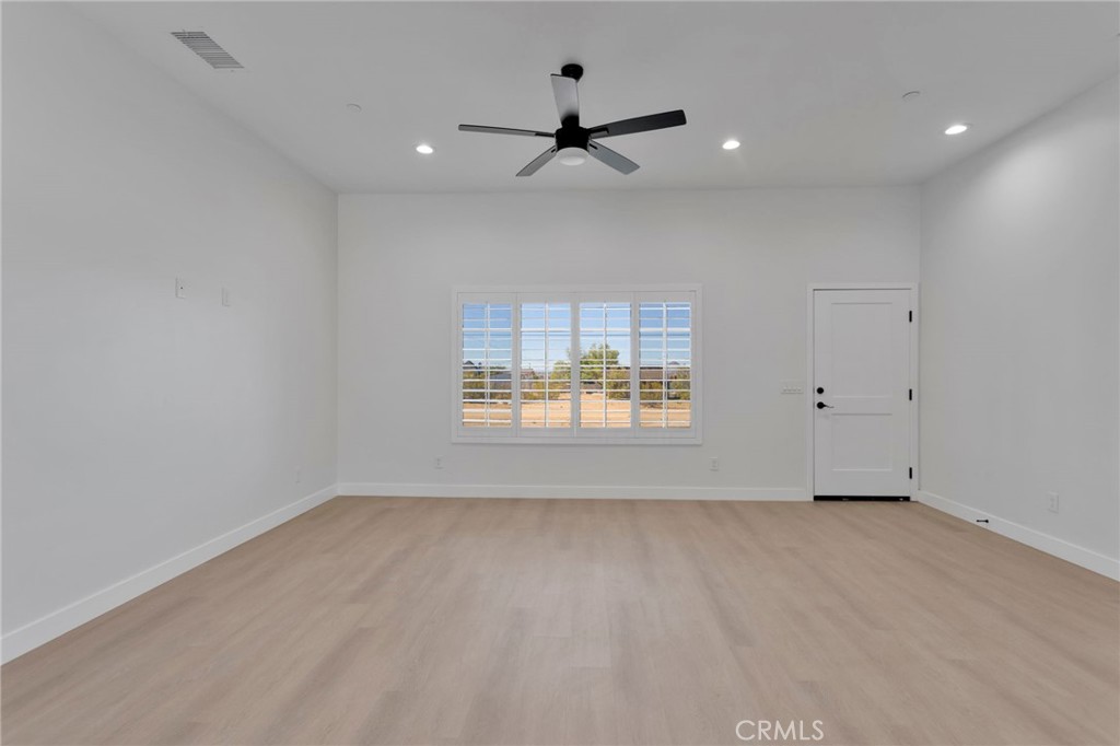 15575 Desert Star Road Apple Valley, CA 92307 - Photo 3 of 24 an empty room with a window