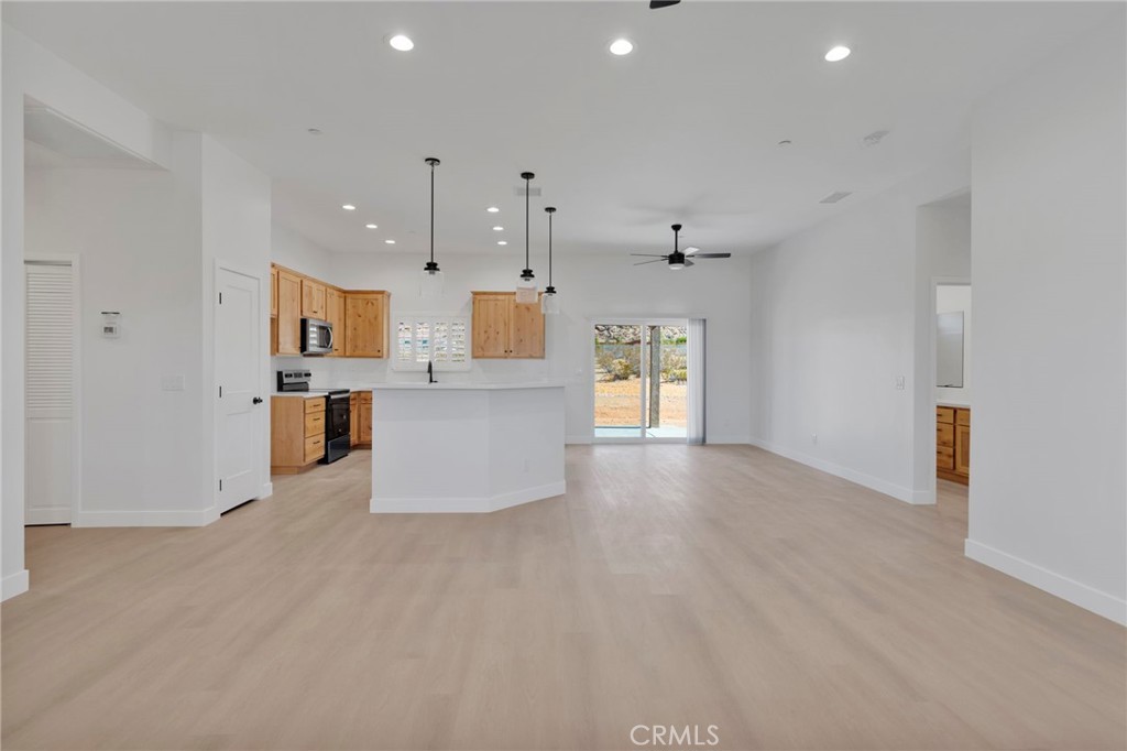15575 Desert Star Road Apple Valley, CA 92307 - Photo 5 of 24 a view of a kitchen with kitchen island and stainless steel appliances