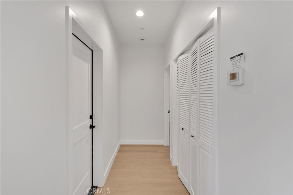 15575 Desert Star Road Apple Valley, CA 92307 - Photo 10 of 24 a view of a hallway with wooden floor