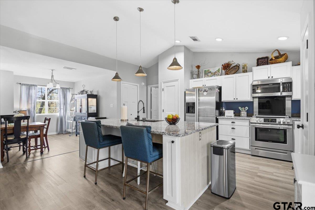 289 Acapulco Road Jefferson, TX 75657 - Photo 1 of 30 a kitchen with stainless steel appliances a stove a sink a dining table and chairs