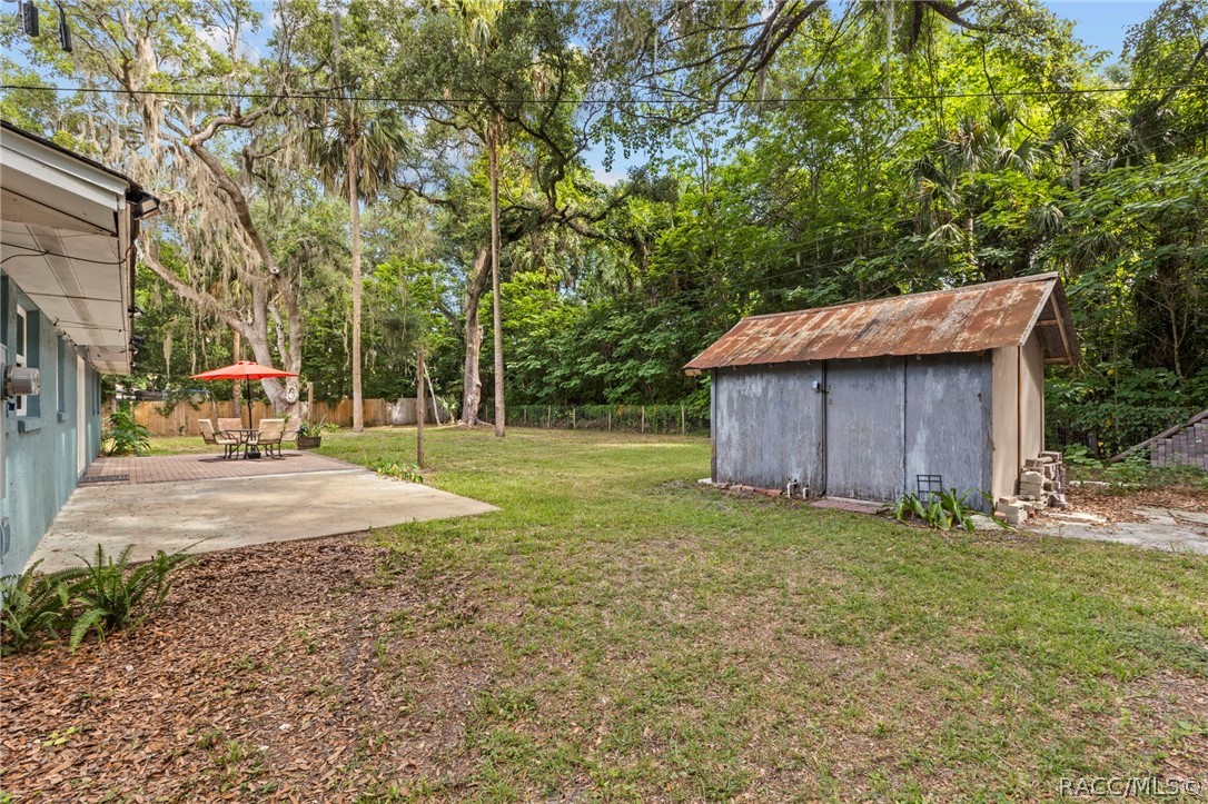 107 Allen Avenue Inglis, FL 34449 - Photo 27 of 36 a backyard of a house with yard and trampoline