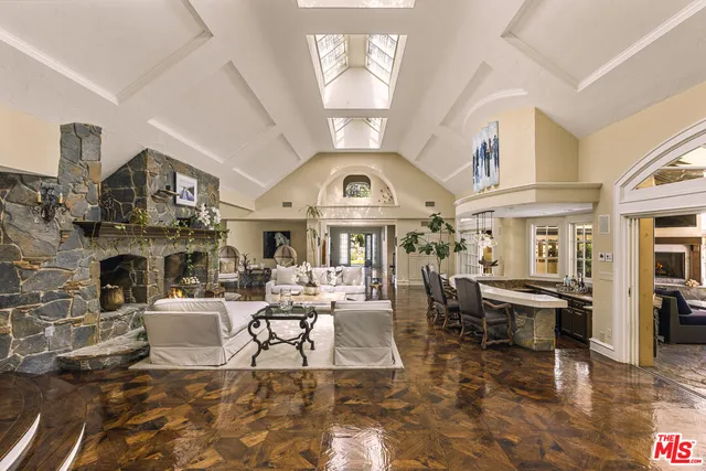 a living room with fireplace furniture and a chandelier