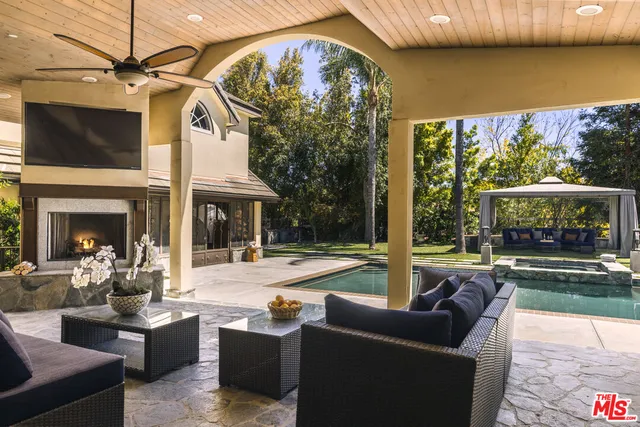 a view of house with garden and swimming pool