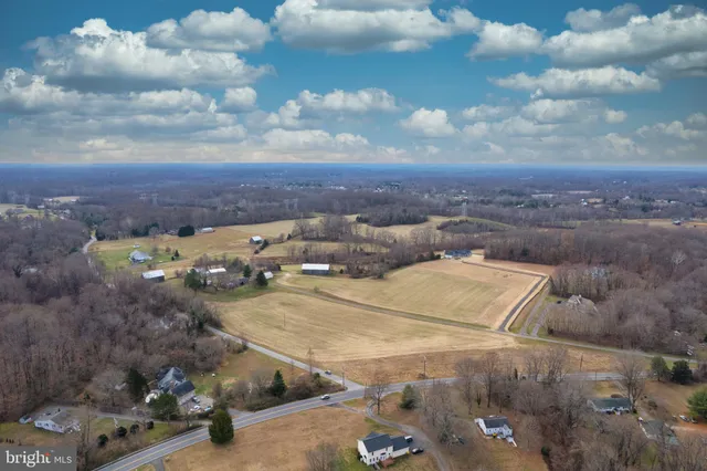 a large white kitchen with lots of counter space a sink and appliances