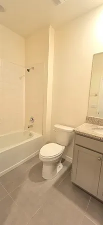 a bathroom with a toilet a sink and bathtub