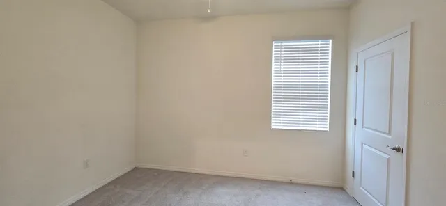 a view of a livingroom with an empty space and a window