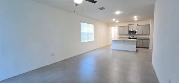 a view of kitchen with sink and microwave