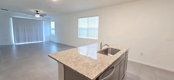 a bathroom with a granite countertop sink and chandelier