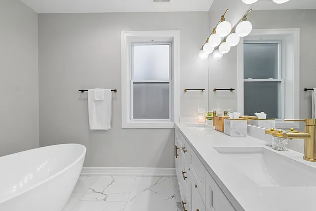 a bathroom with a sink a tub and a mirror